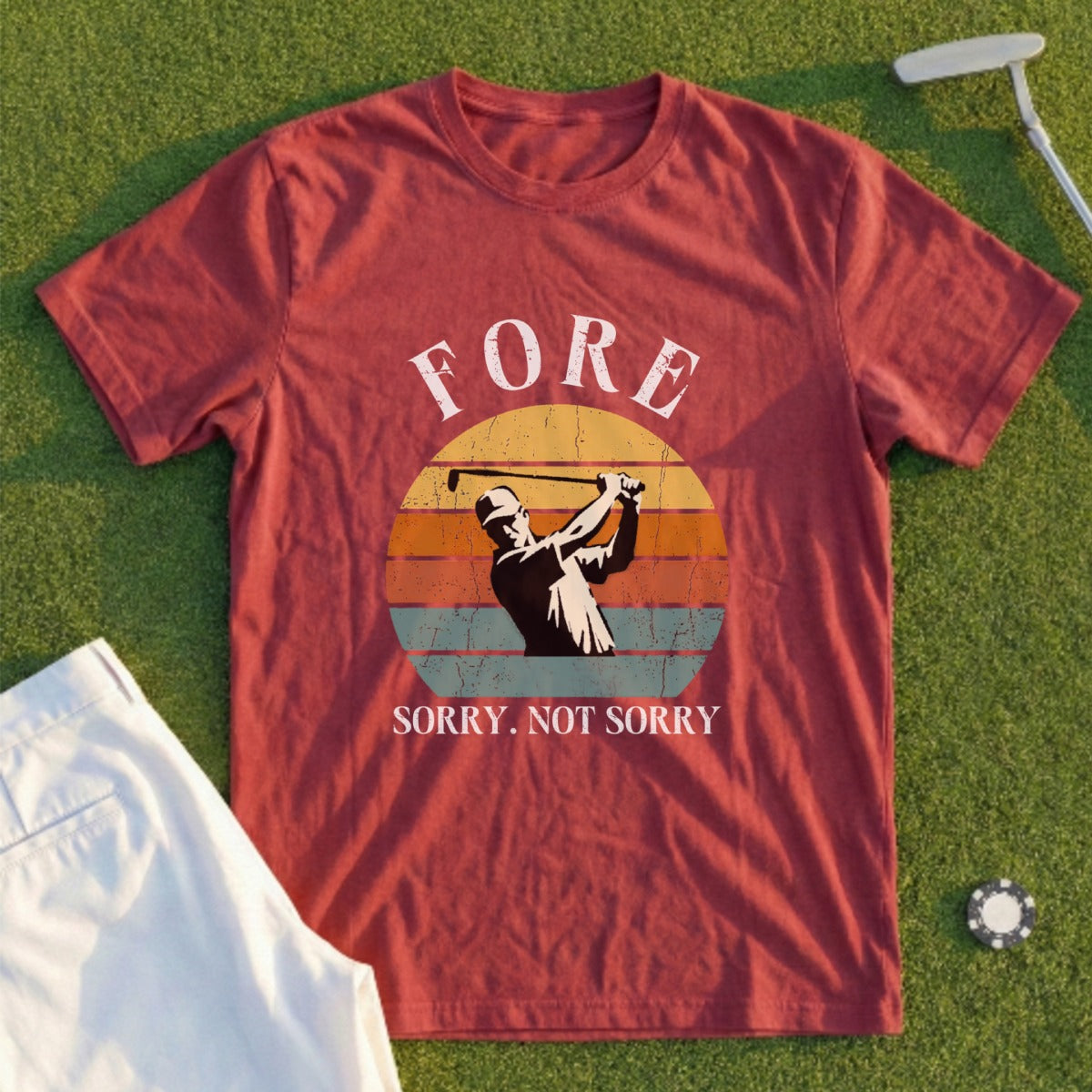 Burgundy t-shirt with a graphic of a golfer mid-swing and the text "FORE SORRY. NOT SORRY."