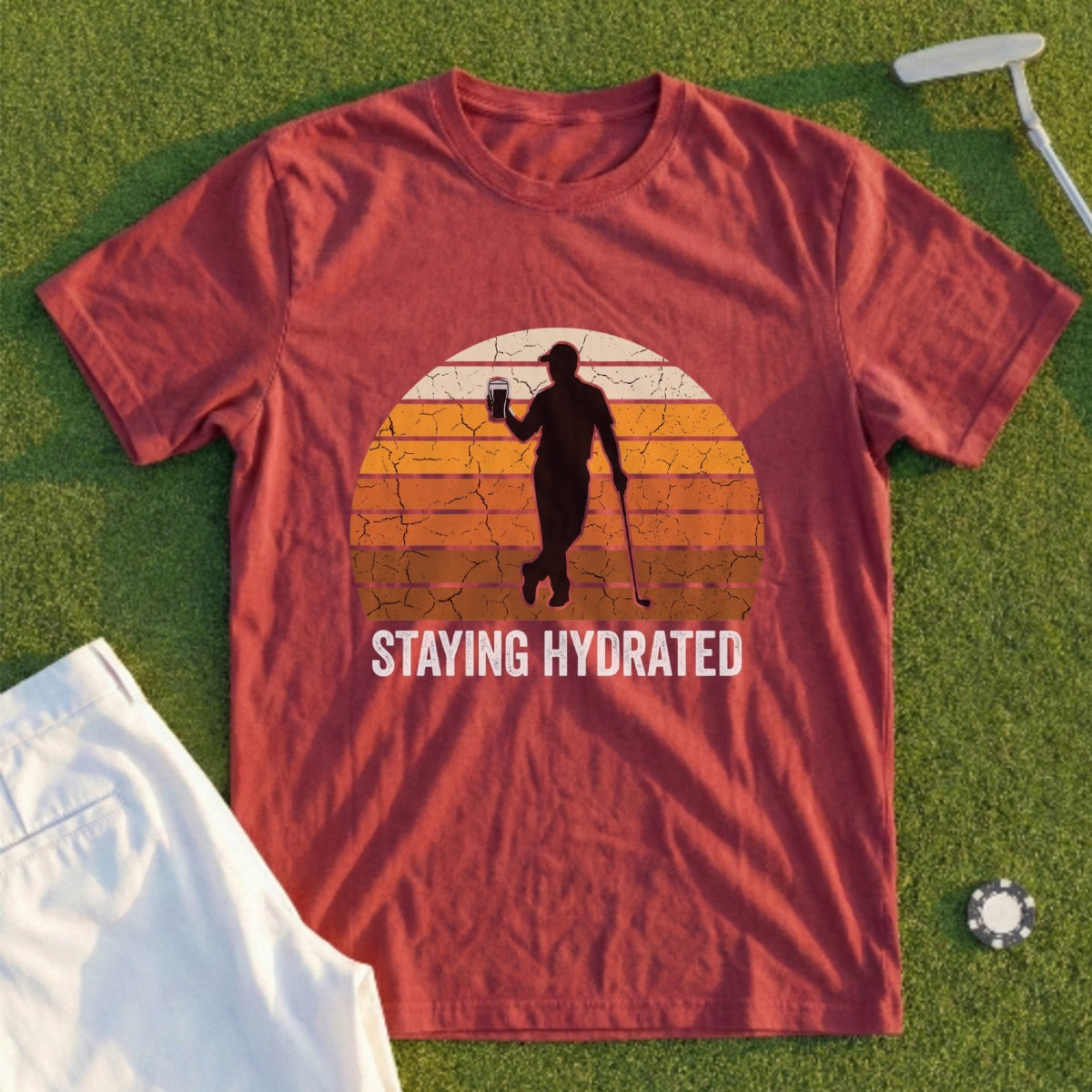 Burgundy t-shirt with a golfer silhouette holding a drink, text "STAYING HYDRATED."