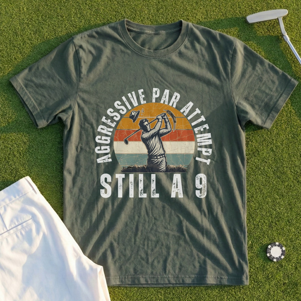 Green t-shirt with graphic of golfer swinging and text "Aggressive Par Attempt Still A 9".