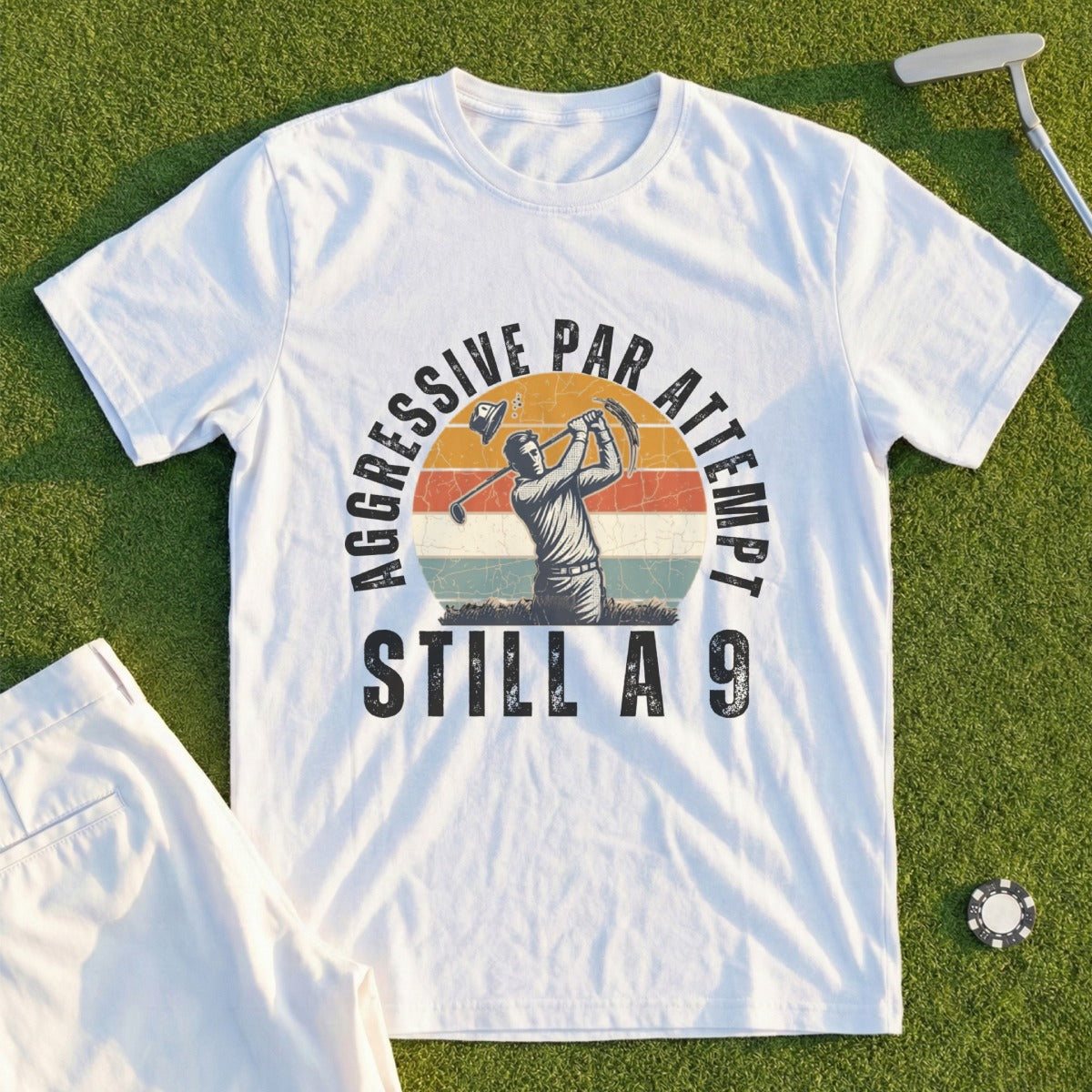 White t-shirt with graphic of golfer and text "AGGRESSIVE PAR ATTEMPT STILL A 9".