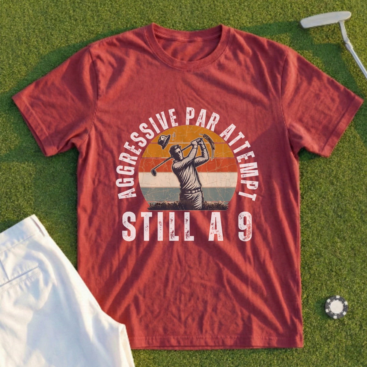 Maroon t-shirt with graphic of golfer, text "AGGRESSIVE PAR ATTEMPT STILL A 9".