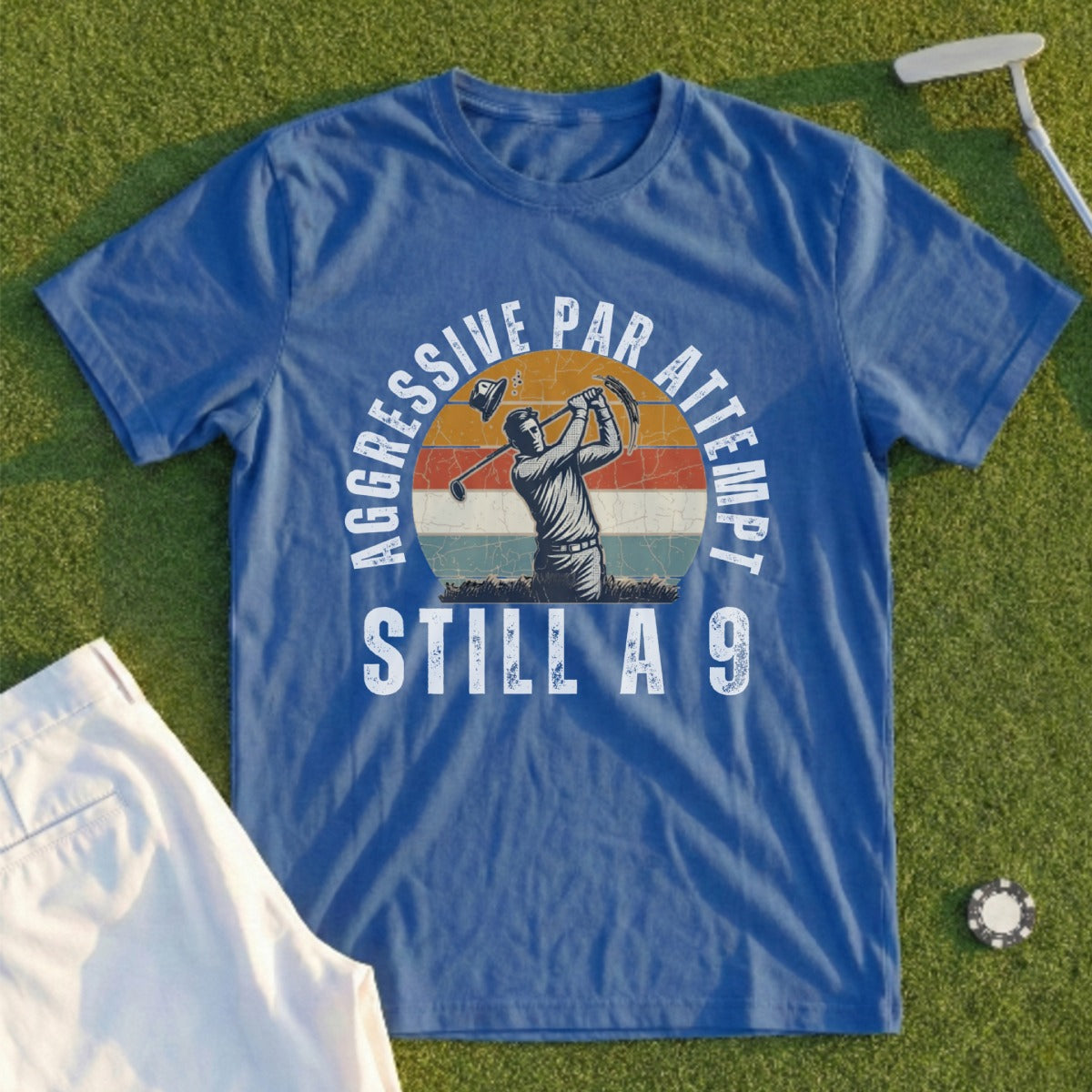 Blue t-shirt with graphic of golfer, "AGGRESSIVE PAR ATTEMPT STILL A 9" text.