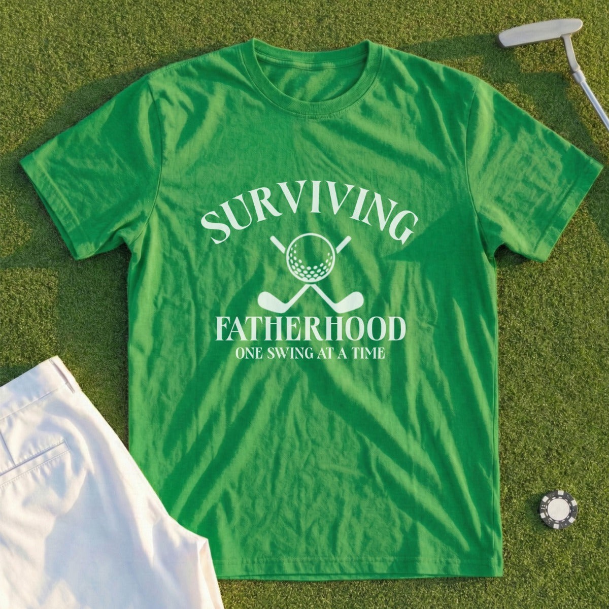 Green t-shirt with "Surviving Fatherhood" and golf club graphics.