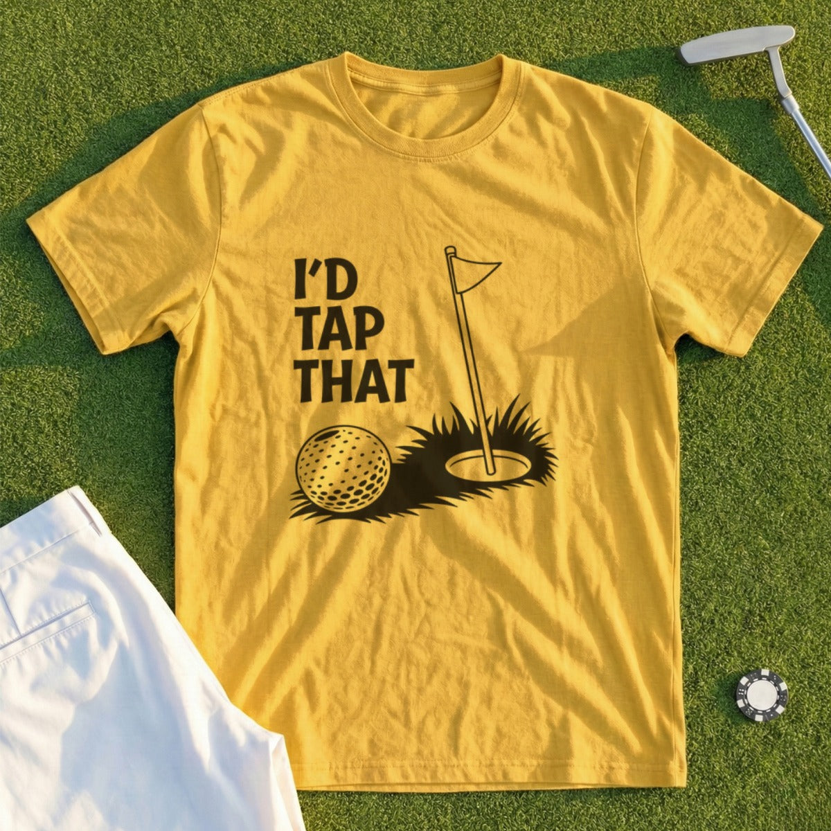 Yellow t-shirt with "I'd Tap That" text, golf ball, hole, and flag.