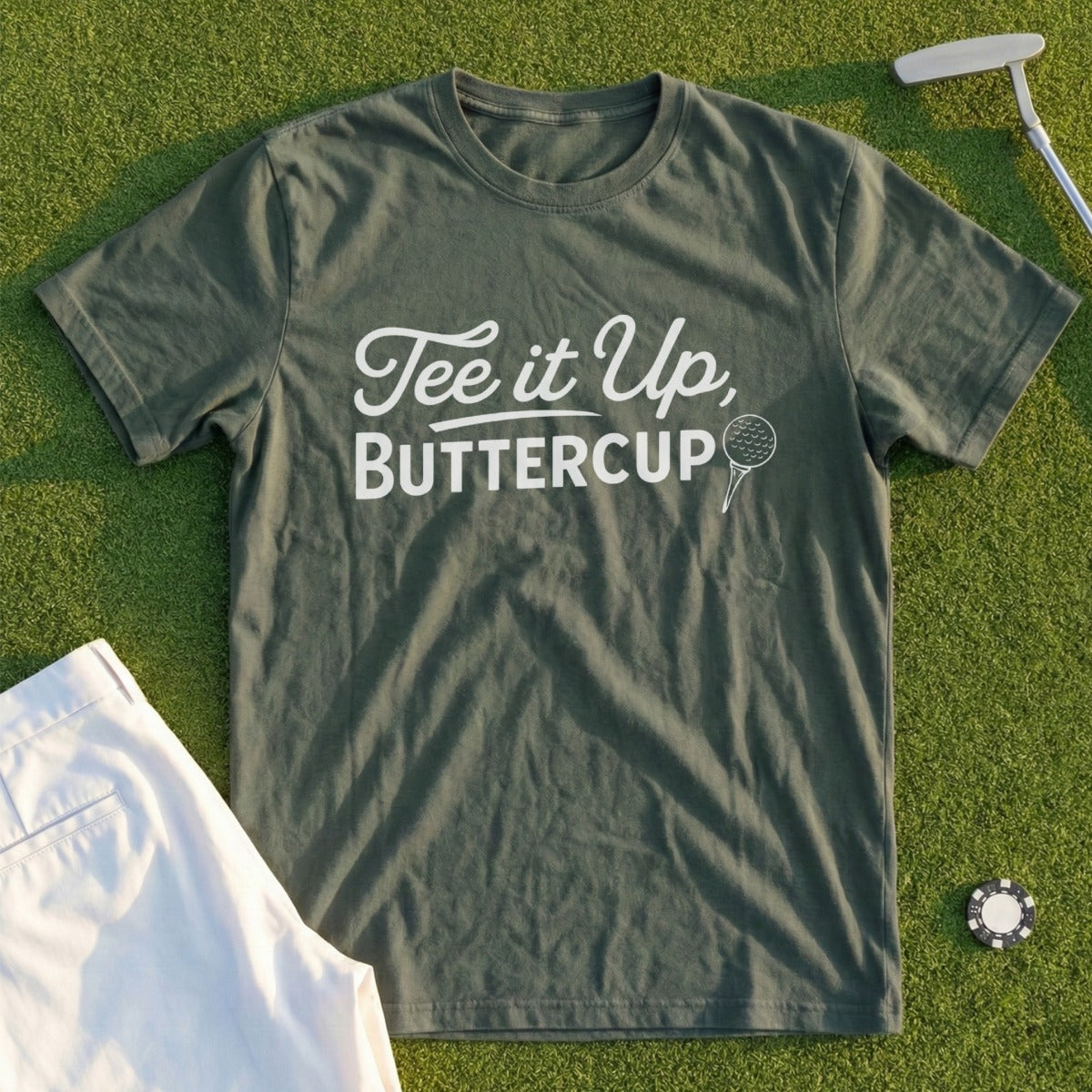 Green t-shirt with white text "Tee it up, Buttercup" and golf ball graphic.