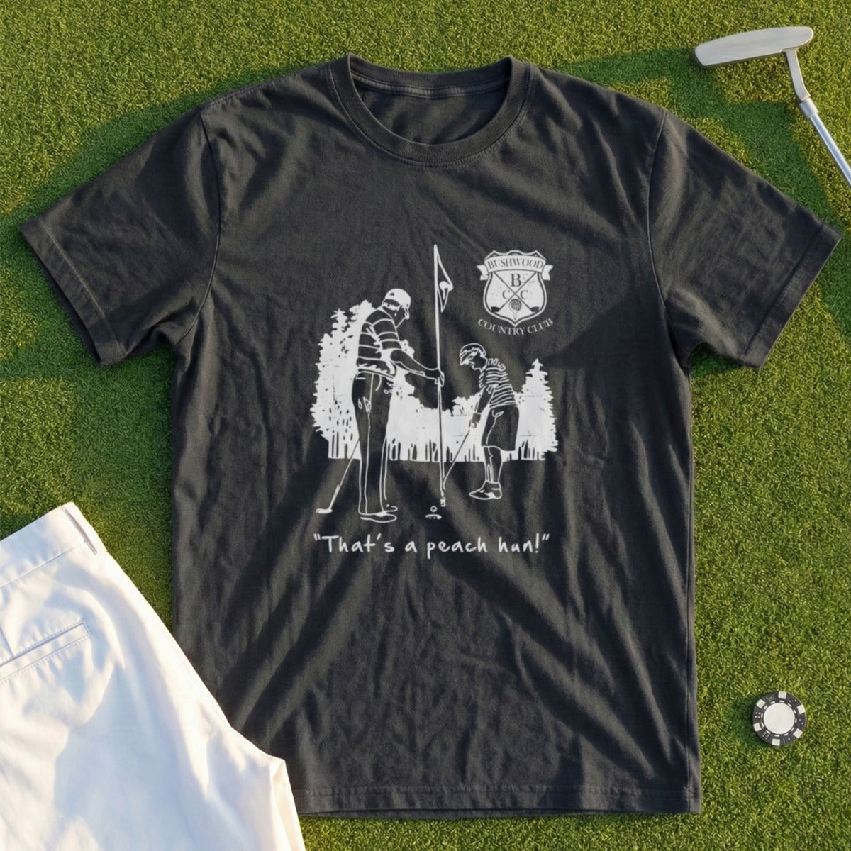 T-shirt with "That's a peach pun!" graphic of golfers on a course.