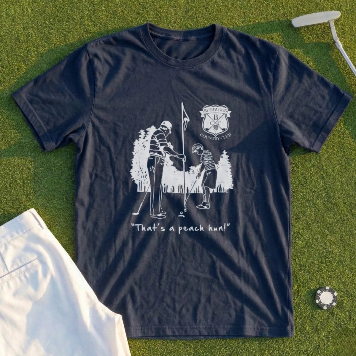 Dark blue t-shirt with golf illustration and "That's a peach pun!" text.