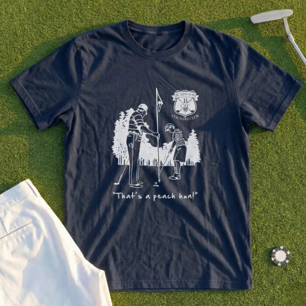 Dark blue t-shirt with golf illustration and "That's a peach pun!" text.