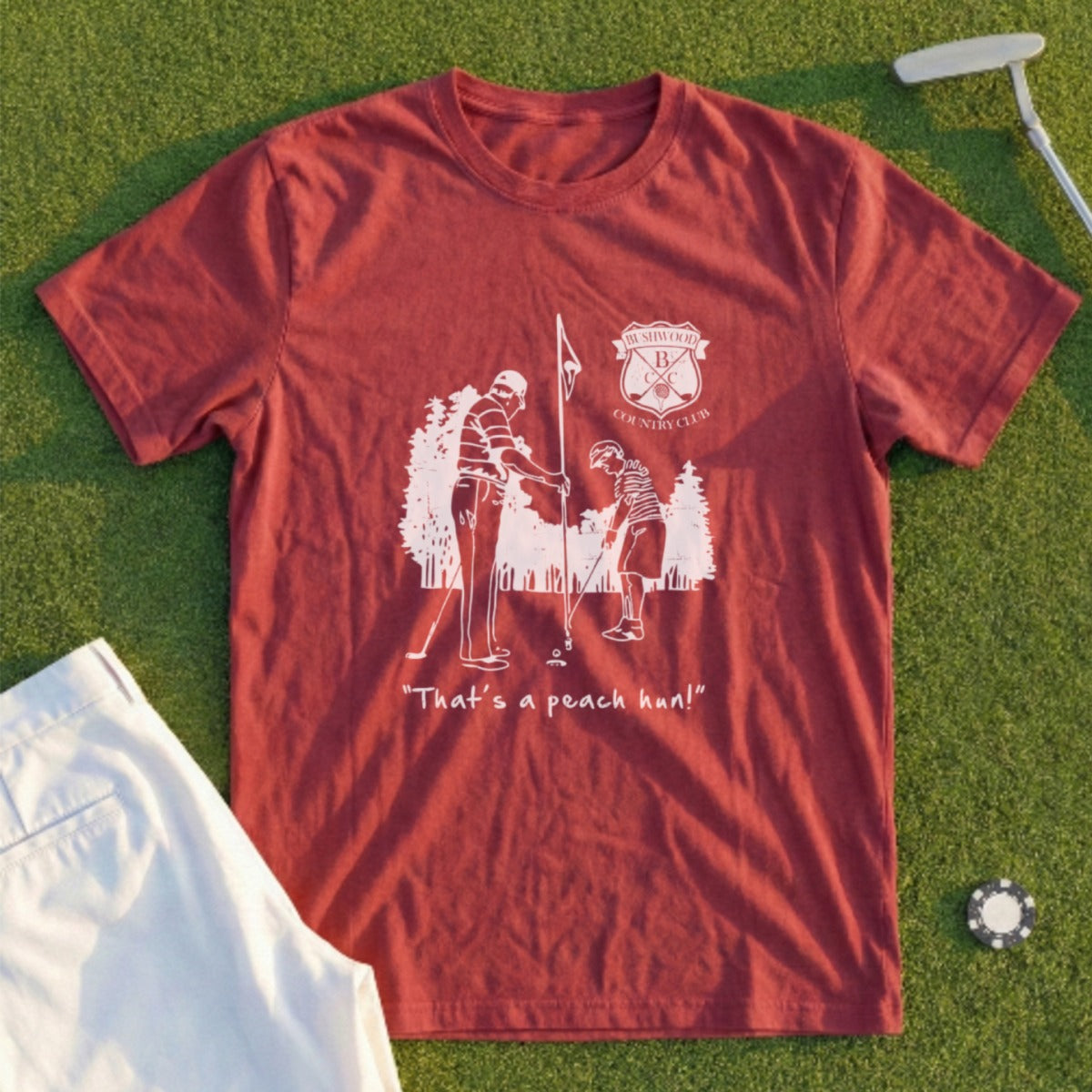 Rustic graphic t-shirt featuring two golfers and "That's a peach hon!" text.