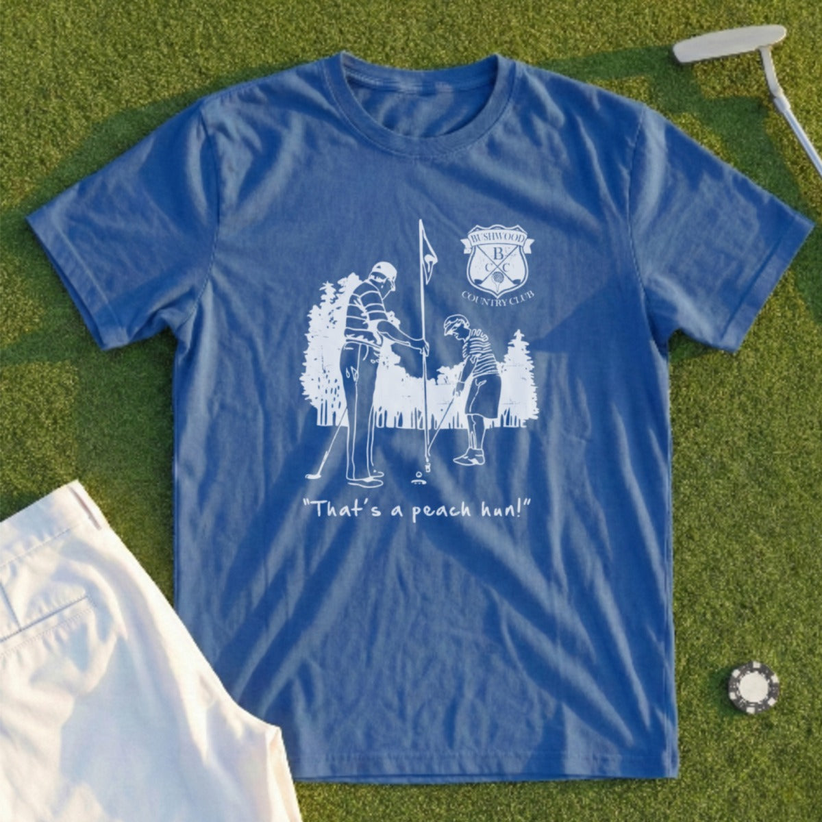 Blue t-shirt with golf illustration and "That's a peach, hun!" text.