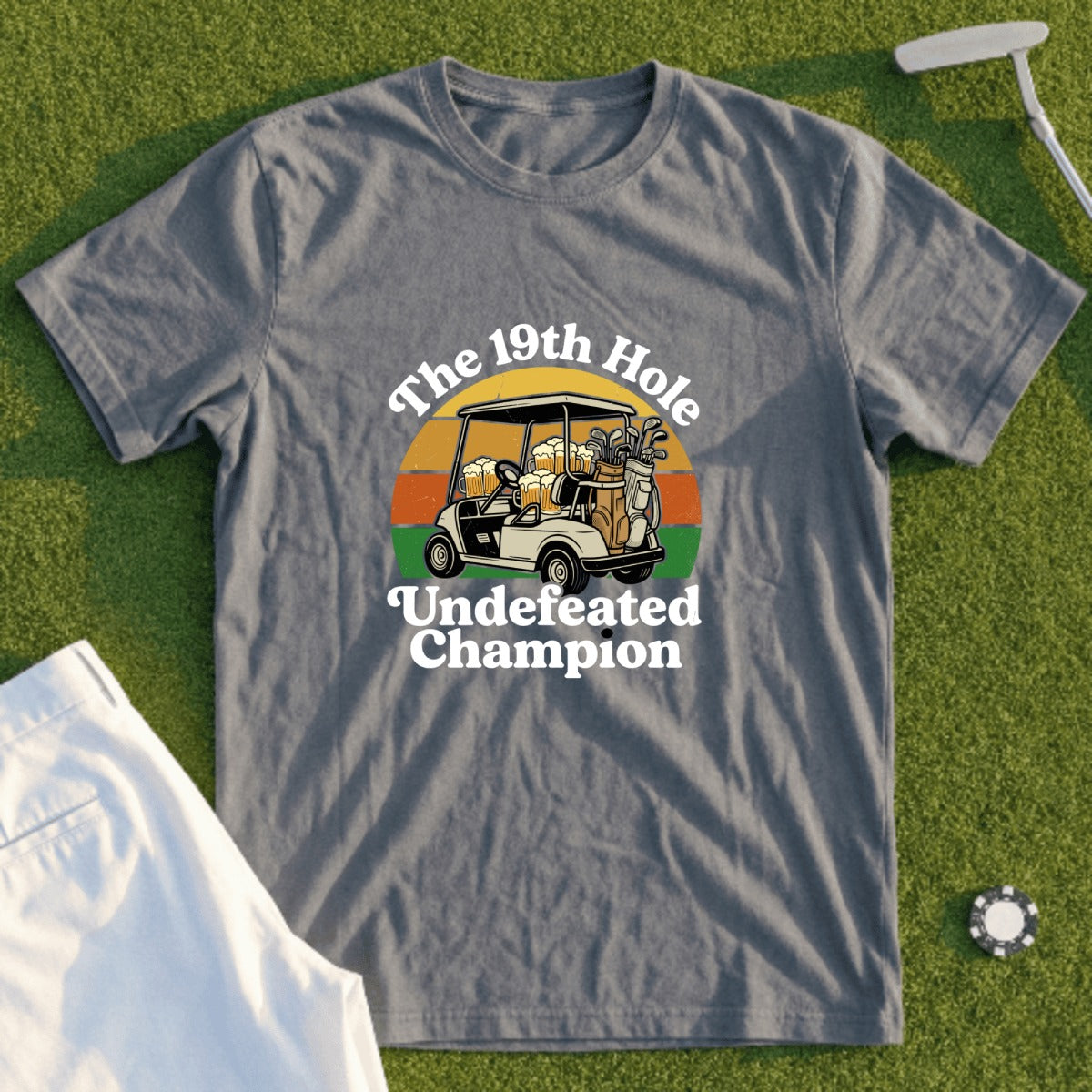 Grey t-shirt with "The 19th Hole Undefeated Champion" text and golf cart graphic.