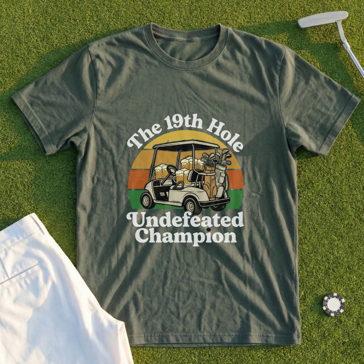 Green t-shirt with "The 19th Hole Undefeated Champion" text and golf cart graphic.