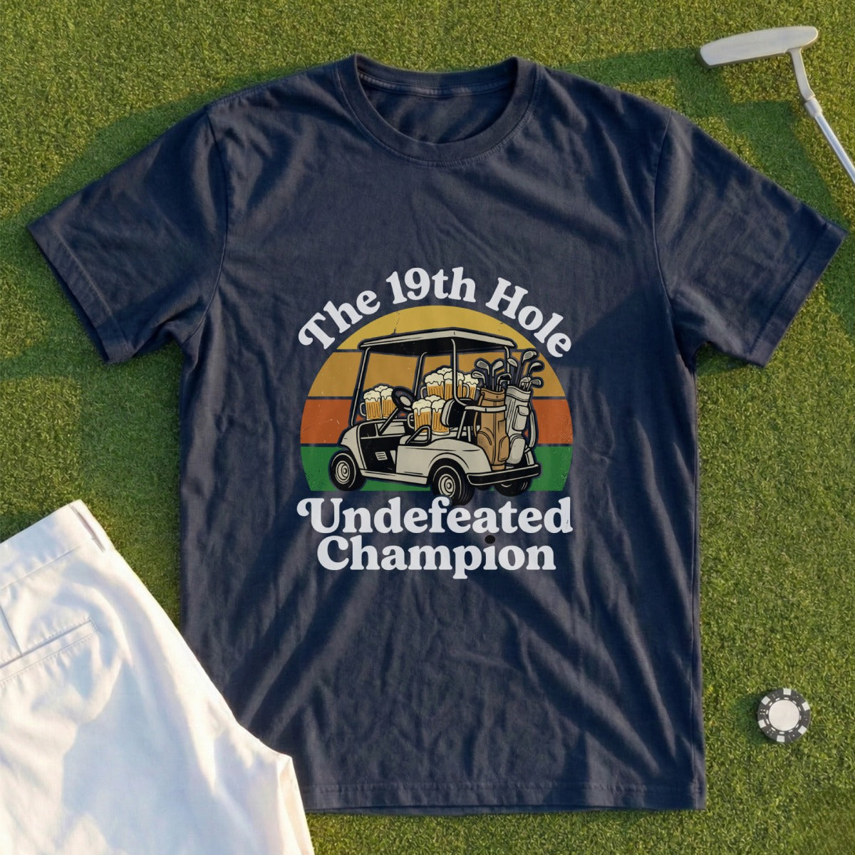 Navy t-shirt with "The 19th Hole Undefeated Champion" text and golf cart graphic.