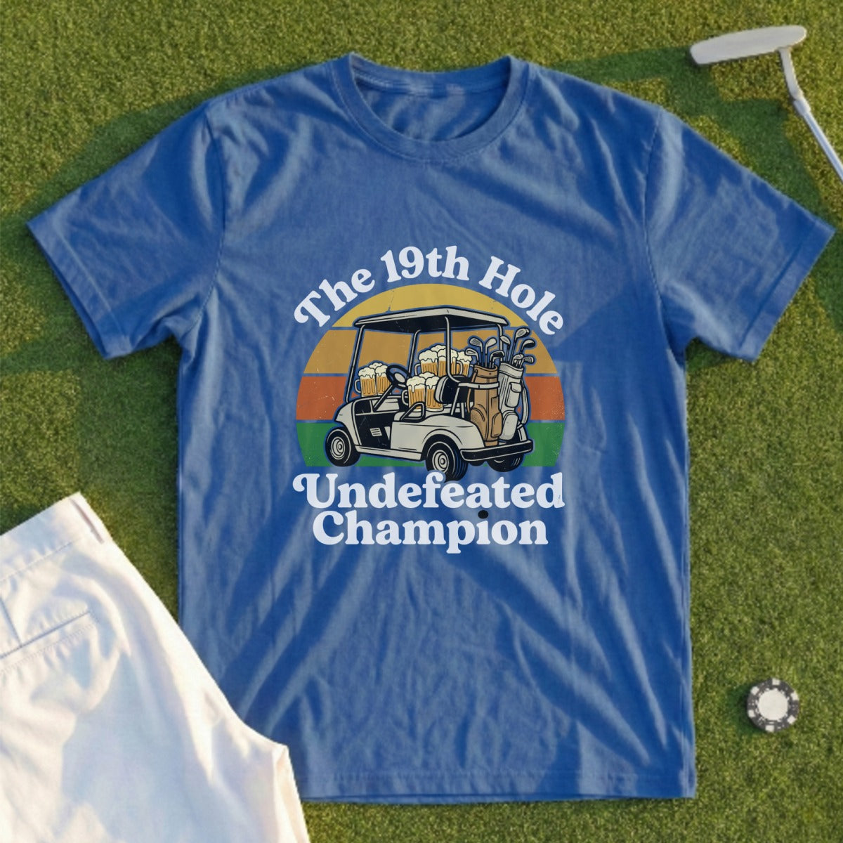 Blue t-shirt with "The 19th Hole Undefeated Champion" text and golf cart graphic.