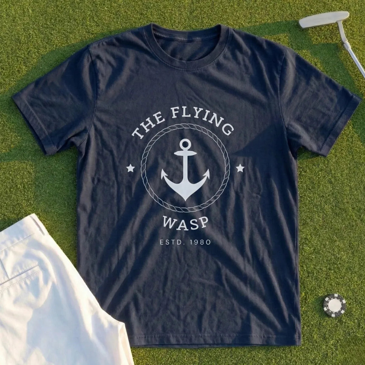 Dark blue t-shirt with white anchor logo and "THE FLYING WASP" text.