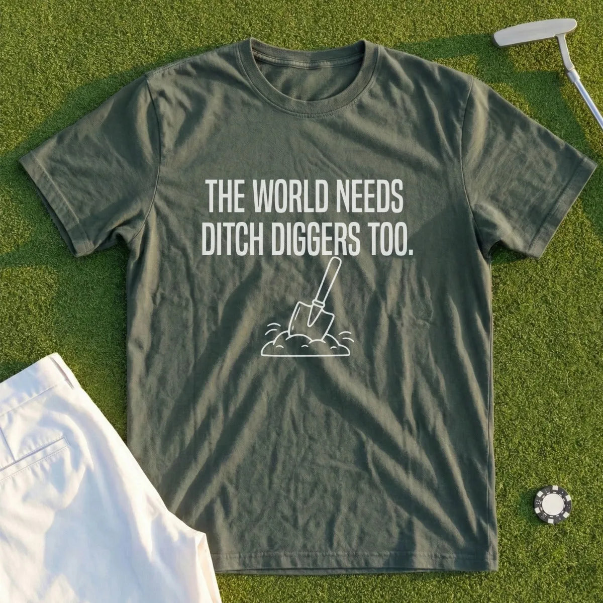 Green t-shirt with white text "The World Needs Ditch Diggers Too" and shovel graphic.