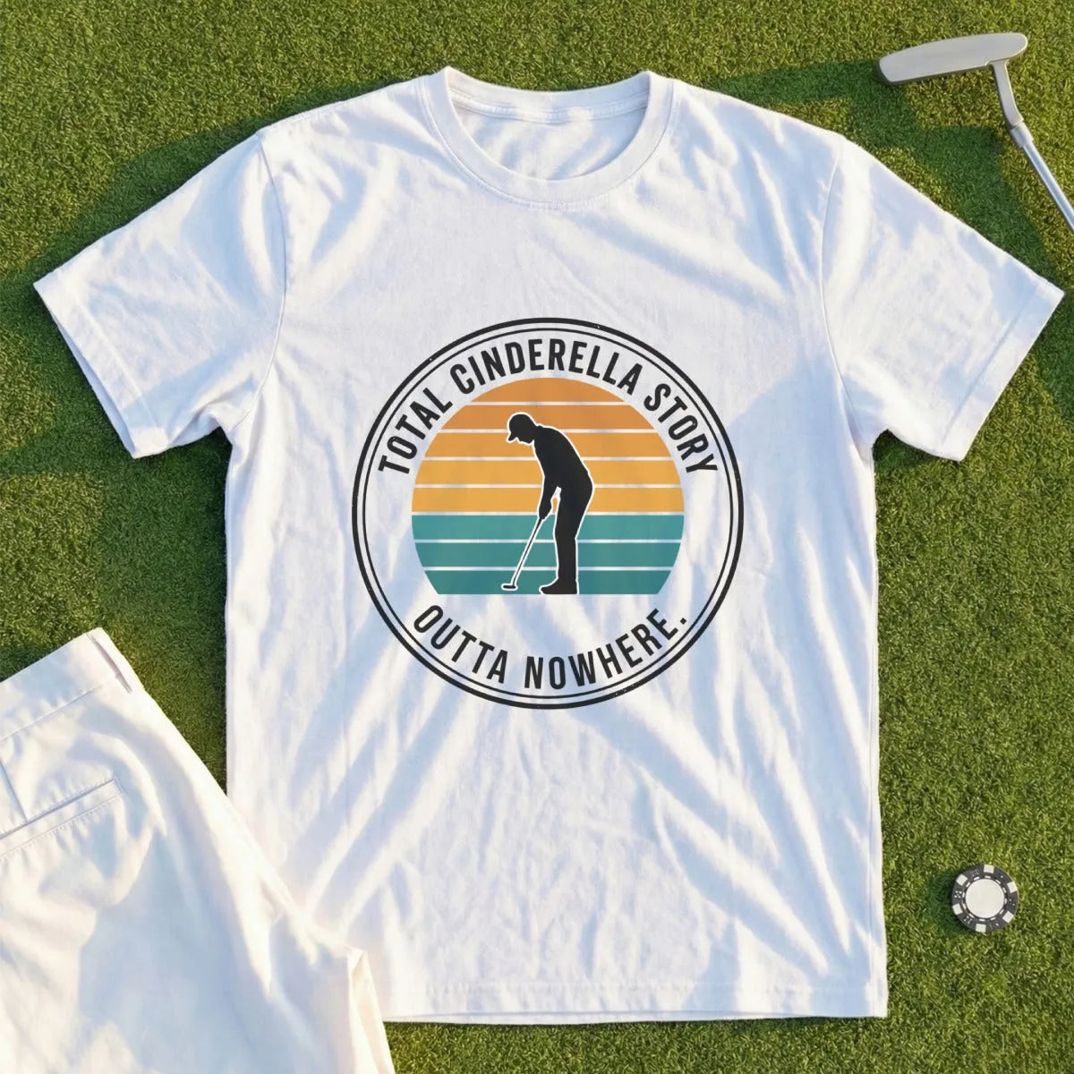 White t-shirt with "Total Cinderella Story Outta Nowhere" text and golfer silhouette.