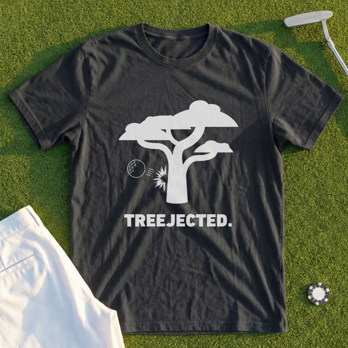 Dark t-shirt with white tree graphic and "TREEJECTED." text on a golf course.
