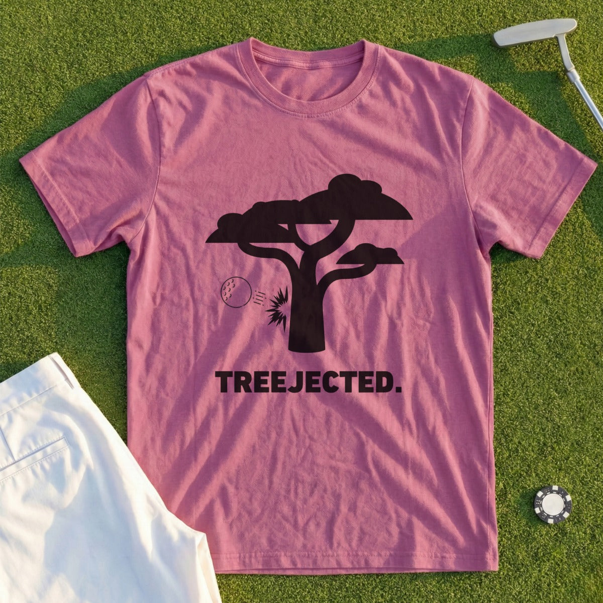 Pink t-shirt with black tree silhouette, golf ball, and "TREEJECTED." text.