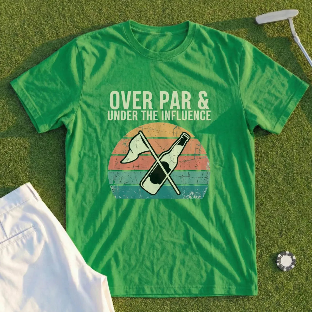 Green t-shirt with "Over Par & Under the Influence" text and bottle graphic.
