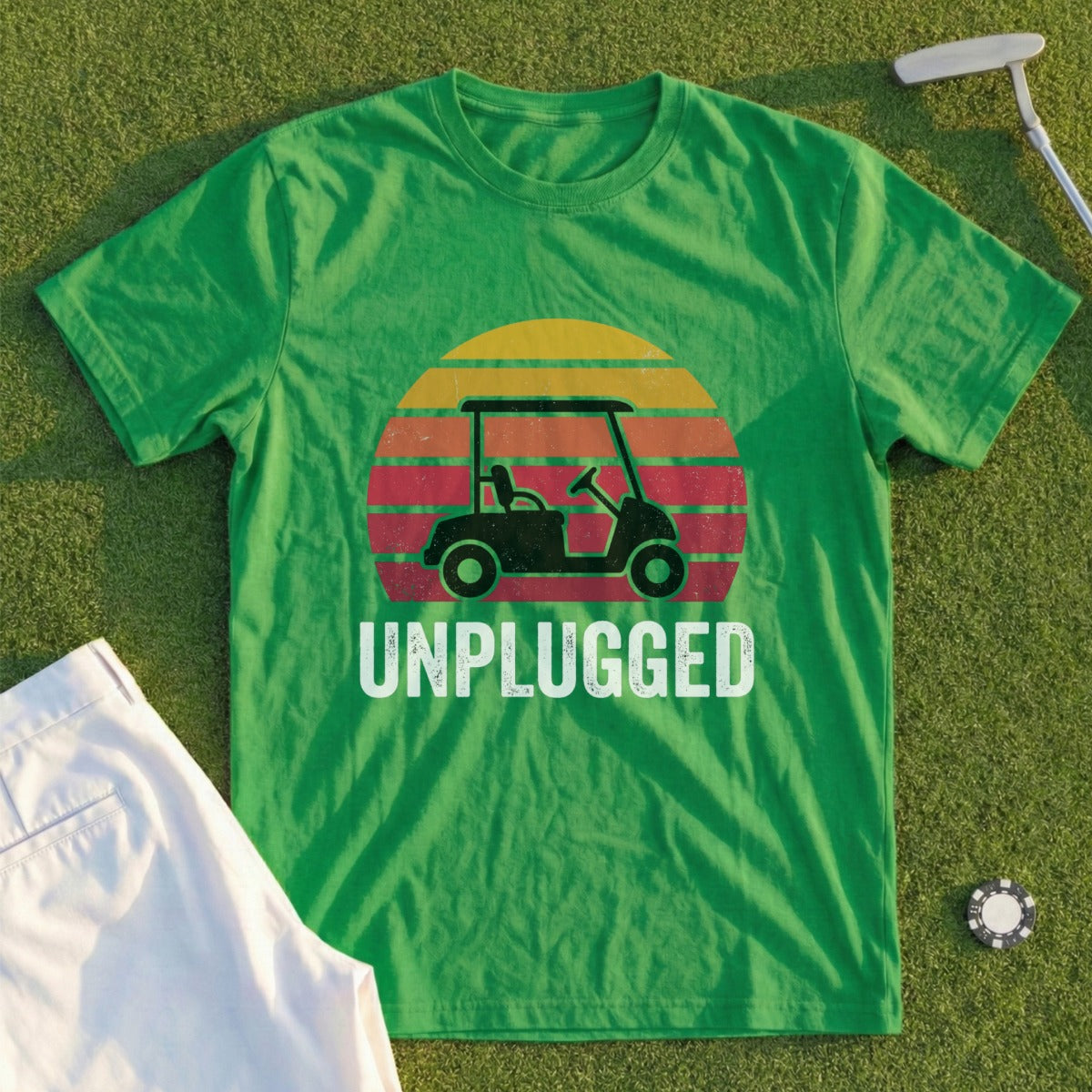 Green t-shirt with a golf cart and sunset graphic, saying "UNPLUGGED".
