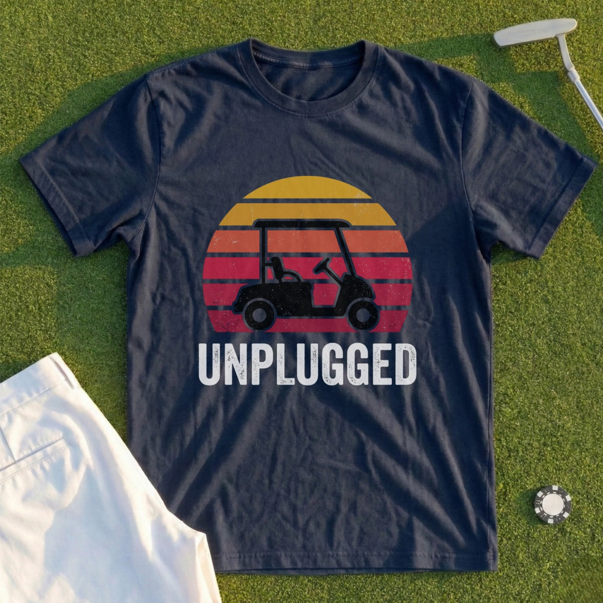 Navy t-shirt with a golf cart and sunset graphic and "UNPLUGGED" text.