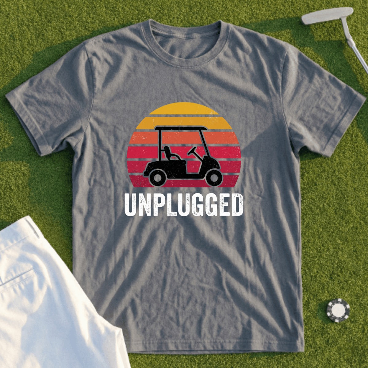 Gray t-shirt with a golf cart and sunset graphic, text "UNPLUGGED".