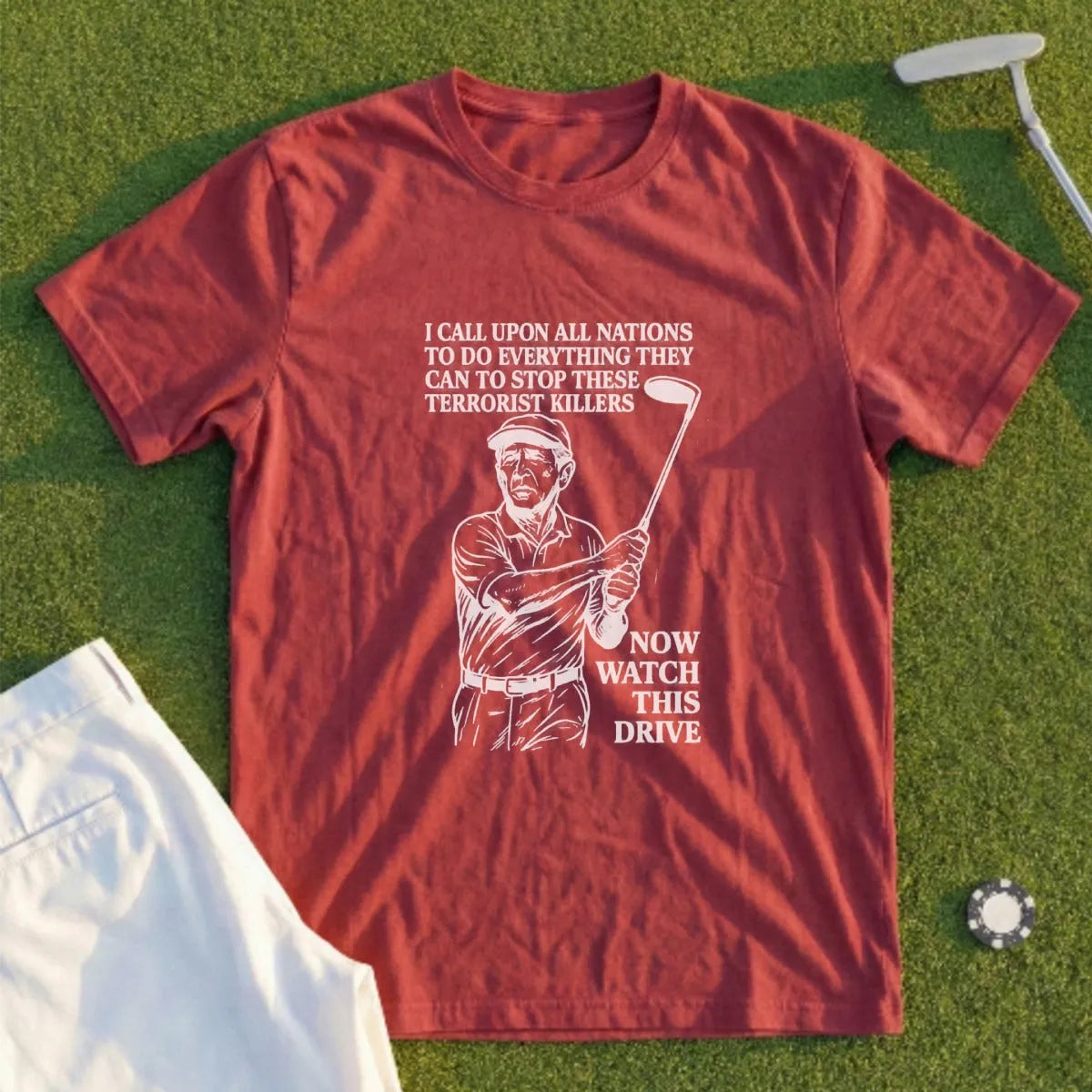 Maroon t-shirt with drawing of golfer and text "NOW WATCH THIS DRIVE".