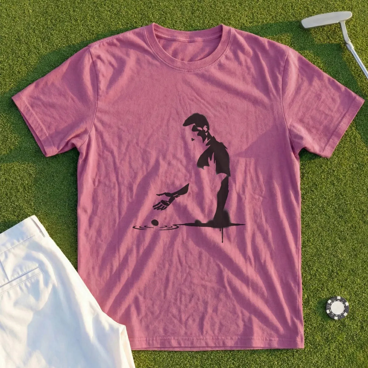 Pink t-shirt with a black graphic of a man playing golf.