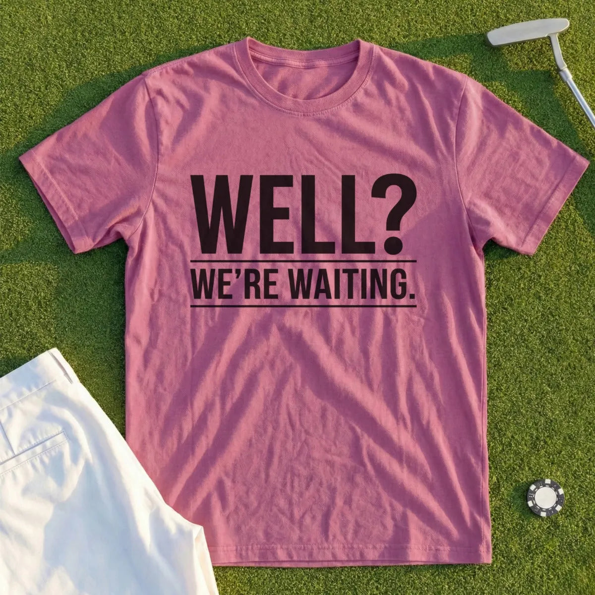 Pink t-shirt with black text that reads "WELL? WE'RE WAITING."