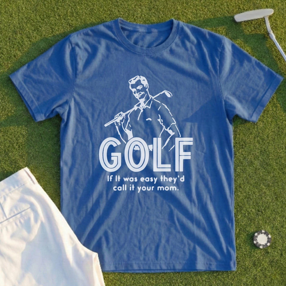 Blue t-shirt with "GOLF" and a golfer graphic, on green grass.