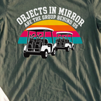 Objects In Mirror Are The Group Behind Us Tee, print close-up on Military Green