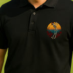 Skeleton Swing Sunset Performance Polo worn on the golf course, Black