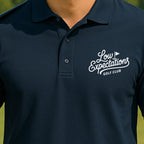 Low Expectations Club Performance Polo worn on the golf course, Navy