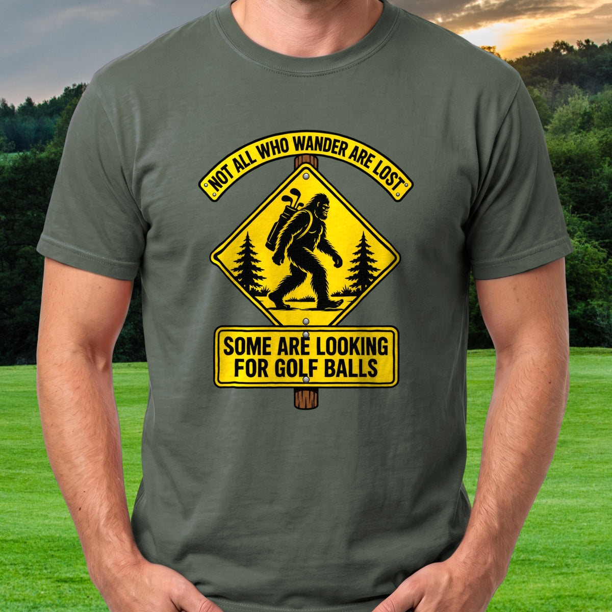 Wandering Sasquatch Road Sign Tee worn on the golf course, Military Green