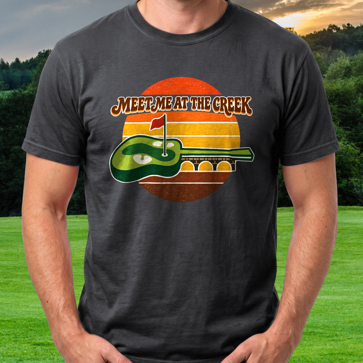 Meet Me At The Creek Retro Sunset Tee worn on the golf course, Black