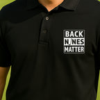 Back Nines Matter Performance Polo worn on the golf course, Black